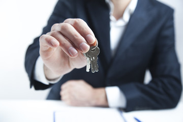 Man hand keys in office table