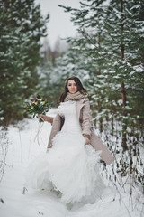 Fototapeta premium The bride against the winter snow-covered forest of firs and pines 852.