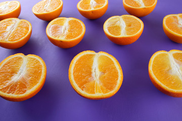 Sliced fruit oranges in checkered pattern on a purple background, symmetrically laid out citrus in pop art style, fruit pattern of halves of oranges, ultraviolet, minimalism