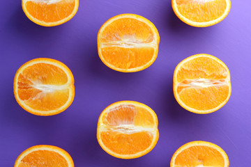 Sliced fruit oranges in checkered pattern on a purple background, symmetrically laid out citrus in pop art style, fruit pattern of halves of oranges, ultraviolet, minimalism