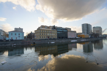 Fototapeta premium Spring Moscow image. The cloud is reflected in the water of the river