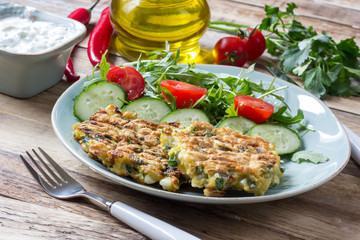 Juicy cutlets on a plate with a salad of tomatoes and arugula