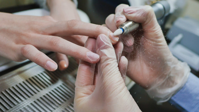 Removing old cover. Woman's hands at manicure procedures