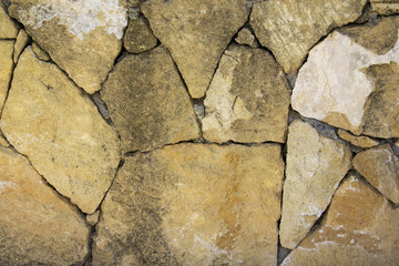 Wall made of big yellow stones background