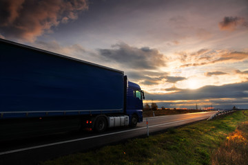 Truck transportation on the road at sunset