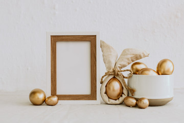 Mock Up Rustic Easter. Frame with gold eggs. Copy Space - obrazy, fototapety, plakaty