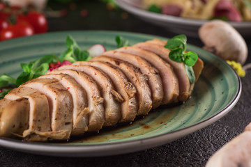 Chicken steak roasted and salad, food photography. Black background. Top view