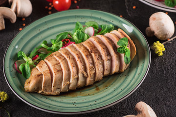 Chicken steak roasted and salad, food photography. Black background. Top view