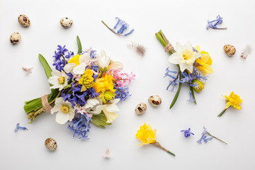 Easter background with quail eggs and spring flowers. Flat lay, top view.