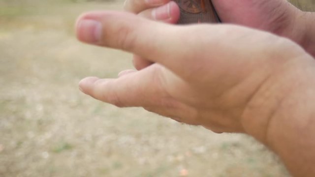 Man loading handgun with ammo clip practicing gun control in slow motion. The shot depicts America's political debate between schoolchildren and the NRA, senseless gun violence and school shootings.