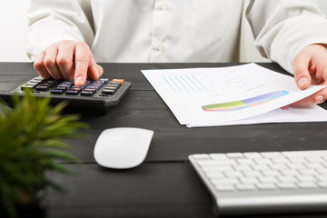 Close up of female accountant or banker making calculations.