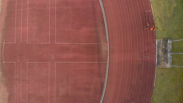 Athlete running along a horizontal track at stadium in public university of Thailand