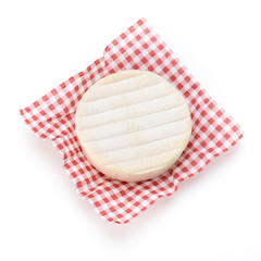 Piece of camembert cheese isolated on white background. From top view.