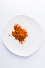 paprika on plate on white background