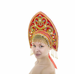 Portrait of Nude smiling girl in a kokoshnik ( headdress ) on a white background.