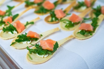 Delicates, appetizer filling with red fish and greens. Catering service.