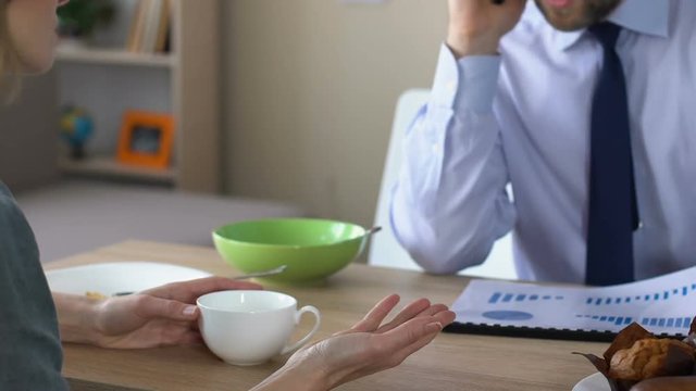 Wife arguing with working husband talking phone at home, family crisis, career