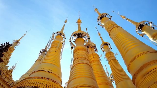 The tall golden stupas of Inn Thein Buddha image Shrine with beautiful hti umbrellas, decorated with bells, Indein (Inn Thein) village, Inle Lake, Myanmar.
