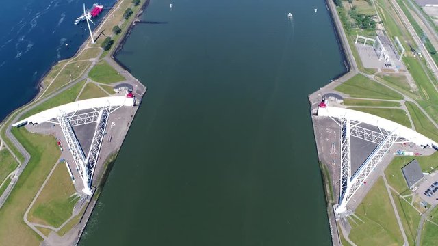 Aerial bird view of large storm surge barrier the Maeslantkering on the Nieuwe Waterweg Netherlands it closes if the city of Rotterdam is threatened by floods and is part of the Delta Works 4k quality