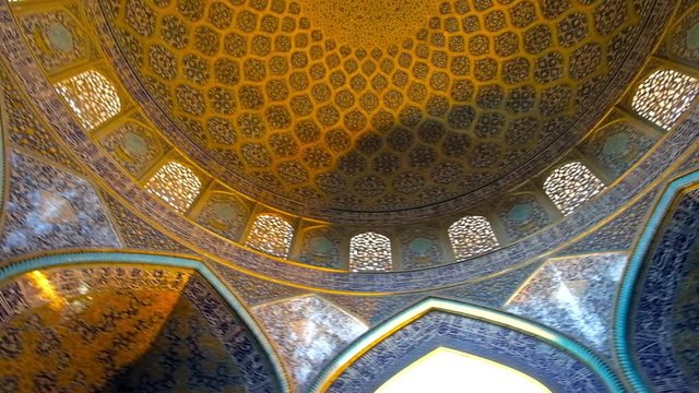 ISFAHAN, IRAN - OCTOBER 21, 2017: Sheikh Lotfollah mosque boasts outstanding interior with tiled arabesque patterns on dome and walls, on October 21 in Isfahan.