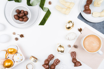 Happy Easter! Stylish stationery background with chocolate eggs. gold and white eggs and accessories on white background. Table decorating for holiday. Feminine flat lay.