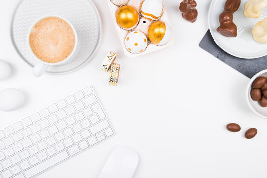 Happy Easter! Stylish stationery background with chocolate eggs. gold and white eggs and accessories on white background. Table decorating for holiday. Feminine flat lay. Office easter concept.