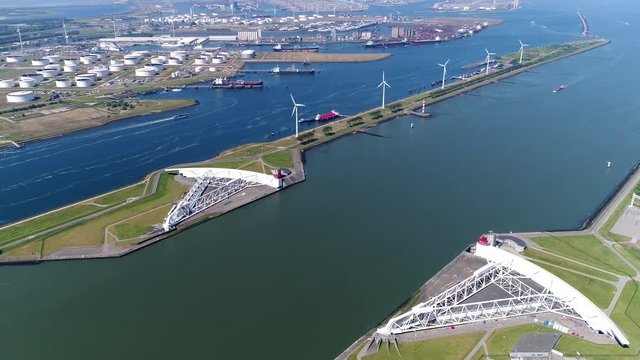 Aerial of large storm surge barrier the Maeslantkering on the Nieuwe Waterweg Netherlands it closes if the city of Rotterdam is threatened by floods and is part of the Delta Works 4k high resolution