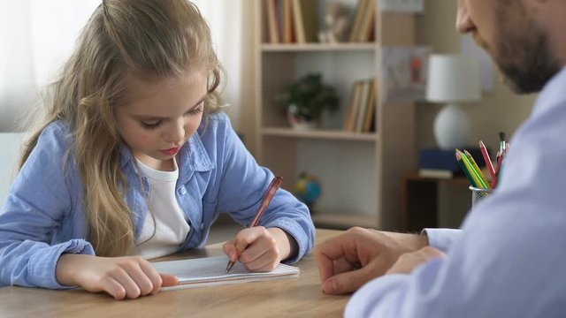 Girl writing exercise notebook with tutor help, additional education, assistance