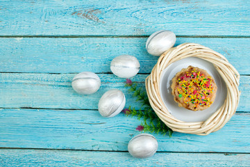 Happy Easter. Painted eggs on wooden table. Easter Cake - Russian and Ukrainian Traditional Kulich, Paska Easter Bread. Top view. Copy space for text.