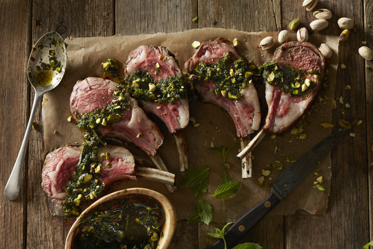 Overhead view of lamb chops prepared with pesto sauce