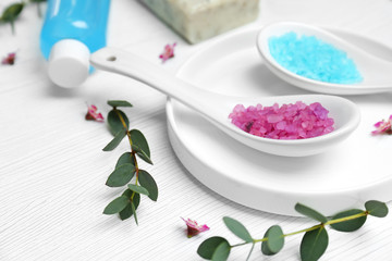 Obraz na płótnie Canvas Spoons with sea salt on table. Spa cosmetics