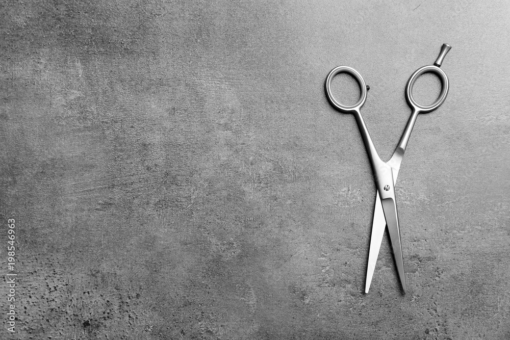 Canvas Prints Professional hairdresser scissors on grey background, top view