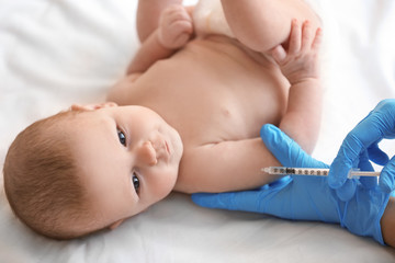 Doctor vaccinating baby in clinic