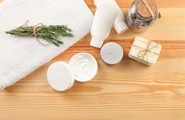 Flat lay composition with body care cosmetics on wooden background
