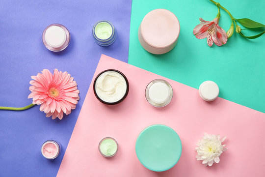 Flat lay composition with body care cosmetics on color background