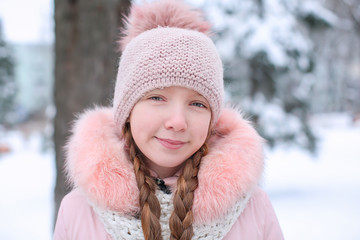 Cute girl in snowy park on winter vacation