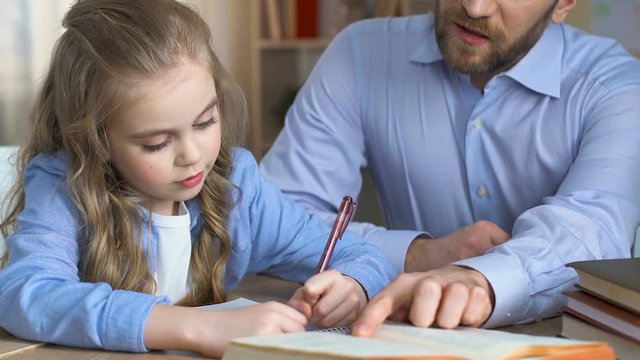 School girl doing homework with teacher, additional education, child development