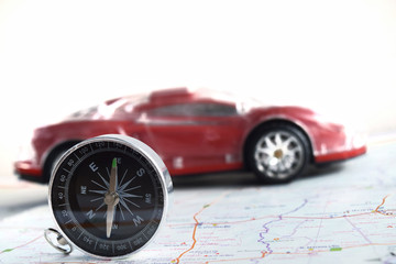 compass and car on map travel concept