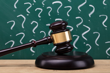 Close-up Of A Gavel On Wooden Desk