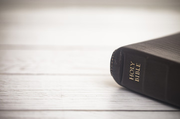 Fototapeta premium Closed Bible on a Wooden Table