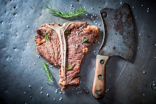 Delicious and fresh tbone steak with herbs and salt