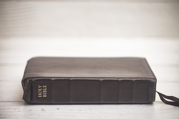 Closed Bible on a Wooden Table