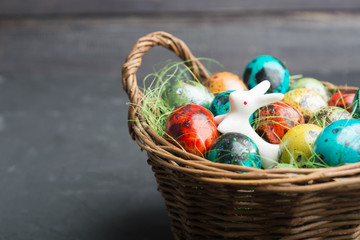 Quail eggs in wicker basket, closeup view with copy space