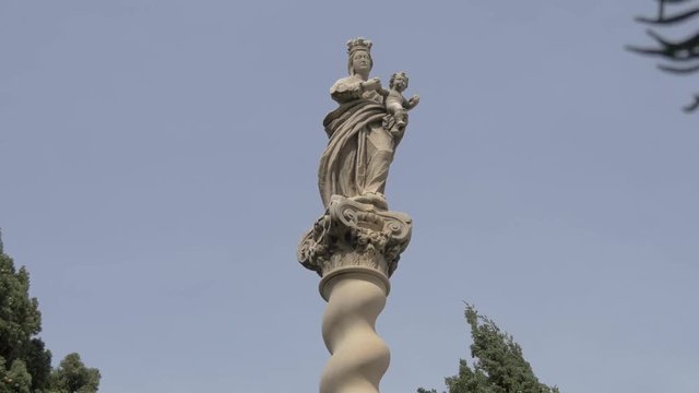 A statue on top of a column