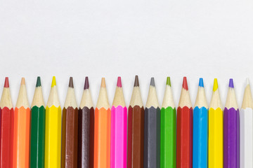Color pencils are neatly stacked vertically in the form of a fence. background
