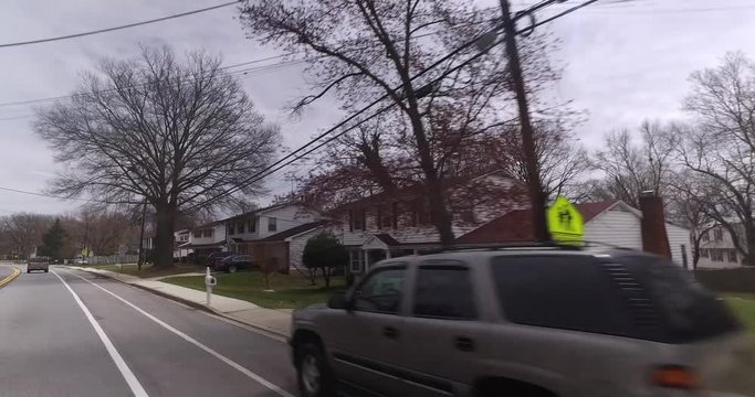Driving past typical homes and houses in the Washington DC area on a late, overcast winter day.  	