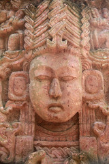 Fototapeta na wymiar Detail of a face from an antient Mayan stone carving, Roatan, Honduras.