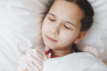 girl sleeping in bed at home