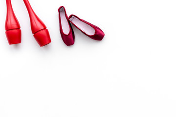 Beauty sport for girls concept. Maces for rhythmic gymnastics and ballet shoes on white background top view copy space