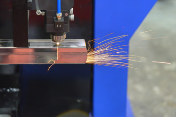 The CNC fiber laser cutting machine cutting the hole at the stainless pipe.
